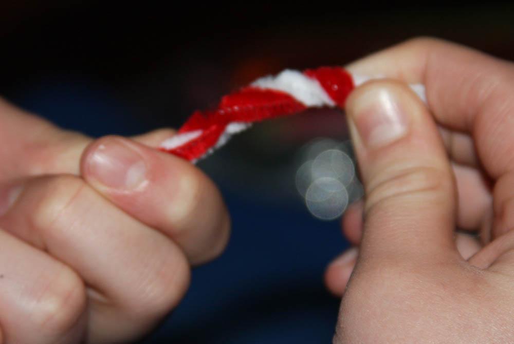 Red and white pipe cleaners twisted together