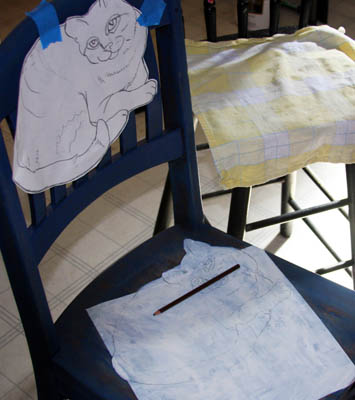 Redraw the tabby cat onto the chair.