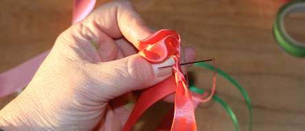 Sew through stem ribbon flower for bracelet.