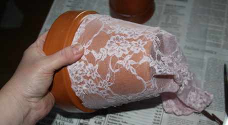 pull lace tight over bottom of clay pot