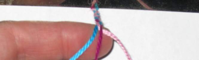 Cross floss on the left over the middle braided bracelet.